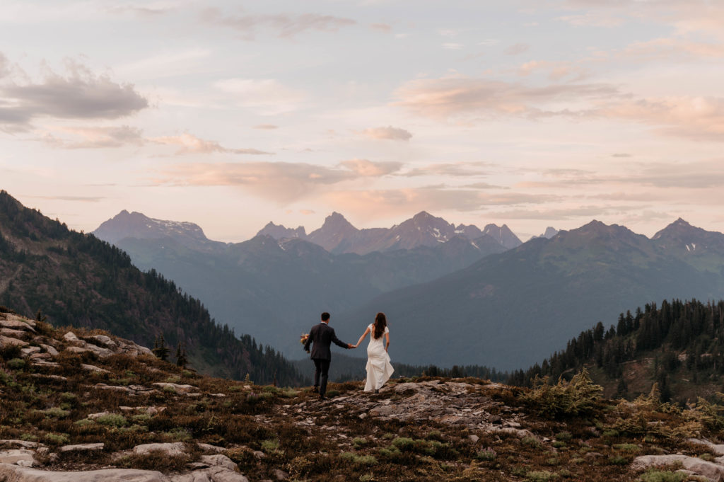 A couple in wedding attire celebrates their wedding and marriage by hiking through the North Cascades.