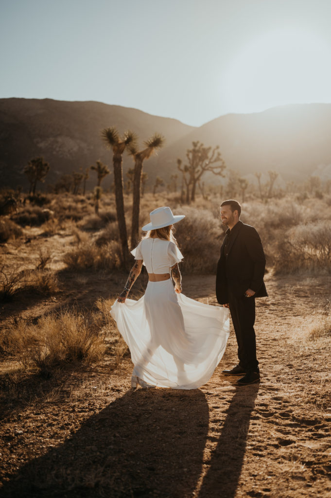 A couple in wedding attire dance after their Joshua Tree Elopement
