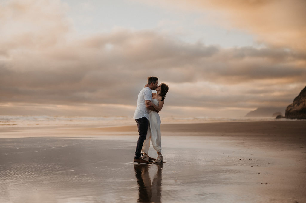 Kissing couple at Hug Point to show off Oregon Coast Elopement locations.