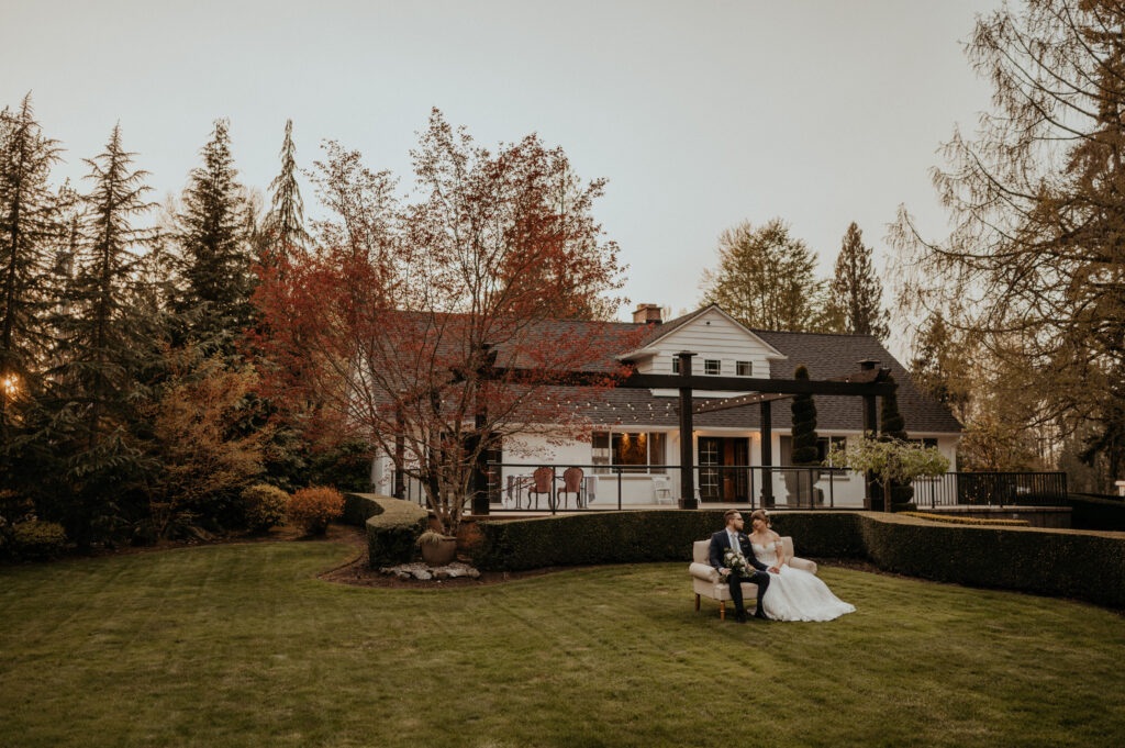 A bride and groom sit together at Rock Creek Gardens in Puyallup, one of Washington's best outdoor wedding venues.
