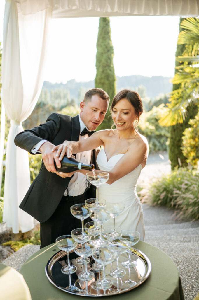 Professional wedding photography of couple pouring champagne during their wedding reception at Chateau Lill in Woodinville, Washington.