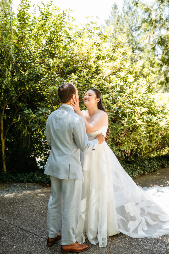 First look reaction photo of a bride seeing her husband for the first time on their wedding day.