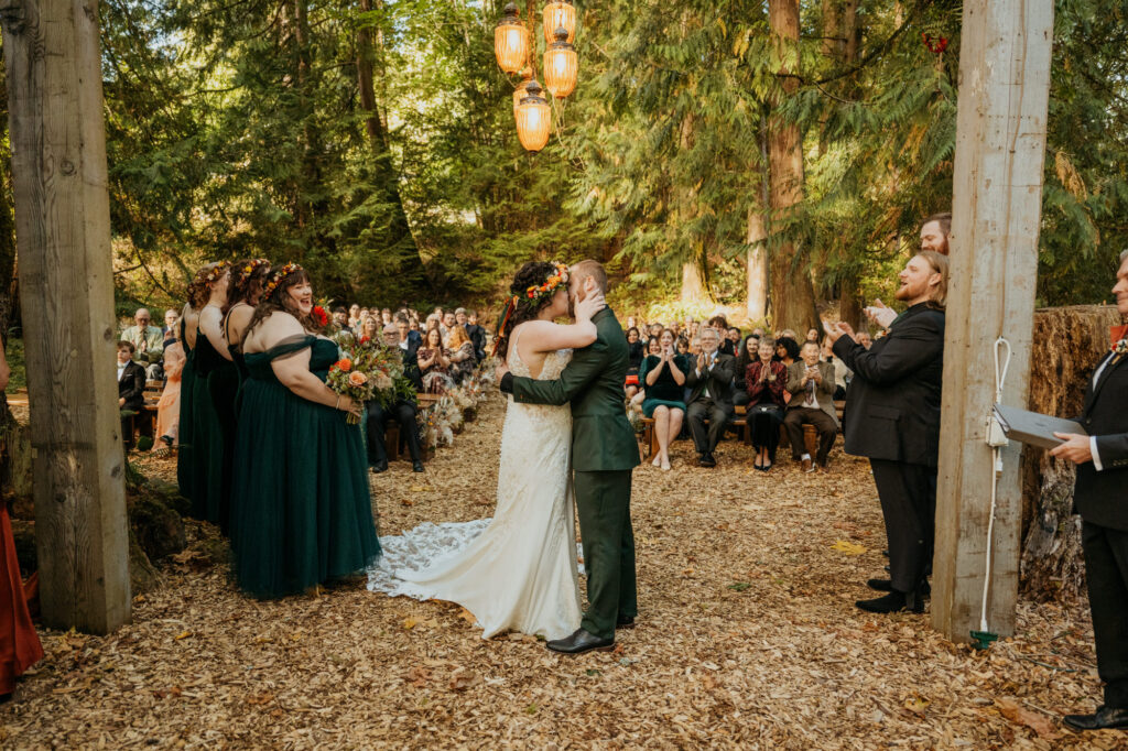 Couple shares their first kiss after their wedding ceremony at Twin Willow Gardens