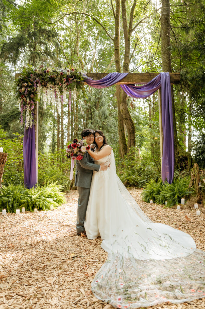 A bride and groom taking wedding photography portraits at Twin Willow Gardens